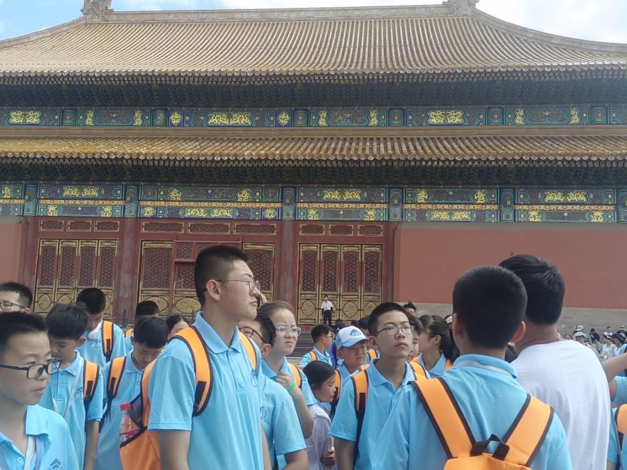 Students on a study tour in front of a hall of the Forbidden City in Beijing