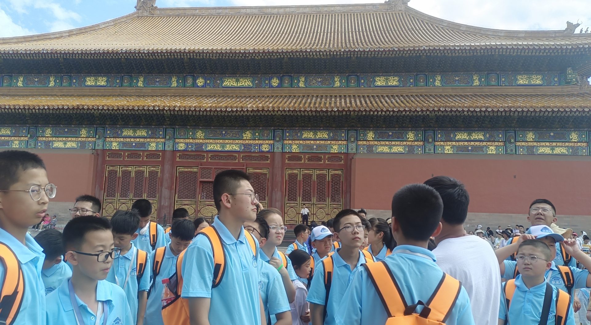 Students on a study tour in front of a hall of the Forbidden City in Beijing