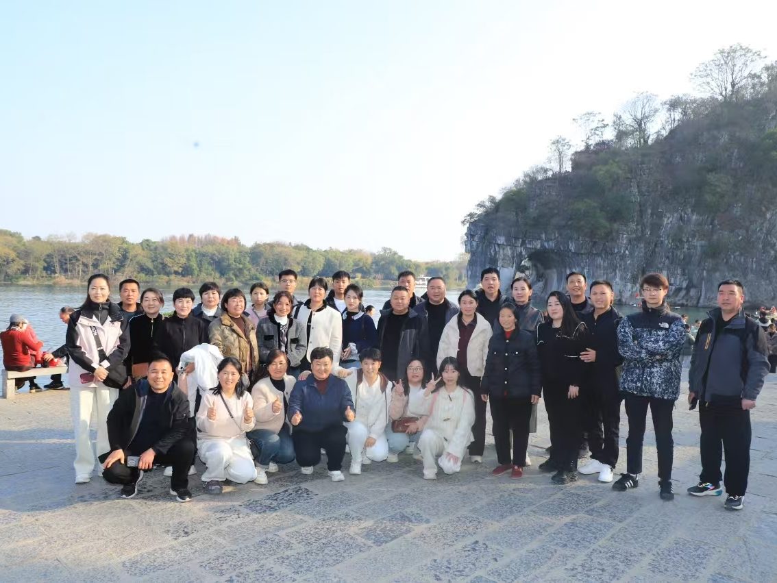 Group photograph of travellers beside the Li River in Guilin