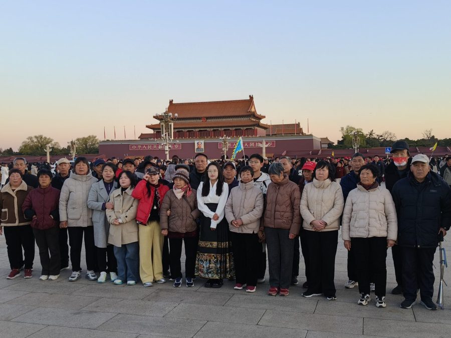 Travellers from a Guolv Culture group standing in front of Tiananmen Gate in Beijing at sunrise