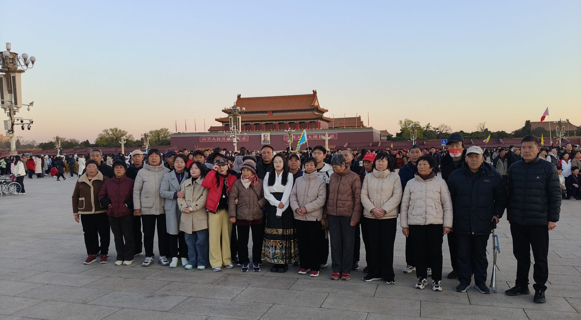 Travellers in front of Tiananmen Gate in Beijing at sunrise