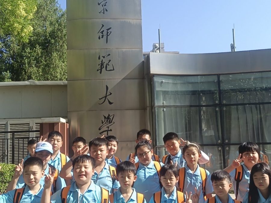 Students in front of the entrance gate of Beijing Normal University on a study programme